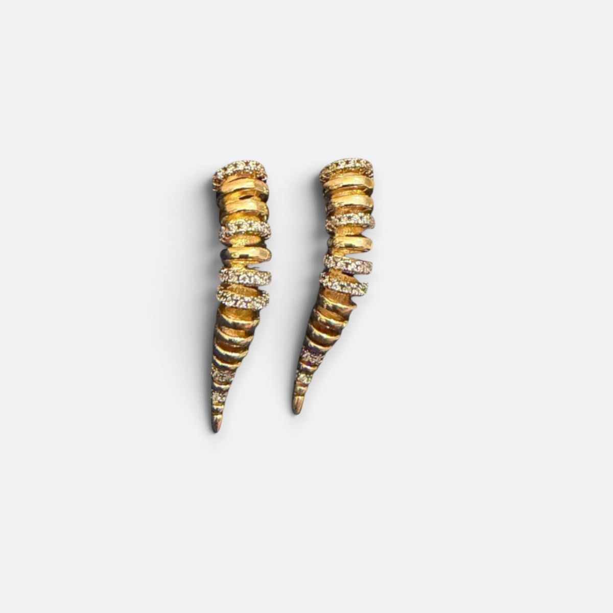 Jakris Zaria gold-plated brass earrings featuring a sculptural, tapered design with sparkling zircon stone accents.