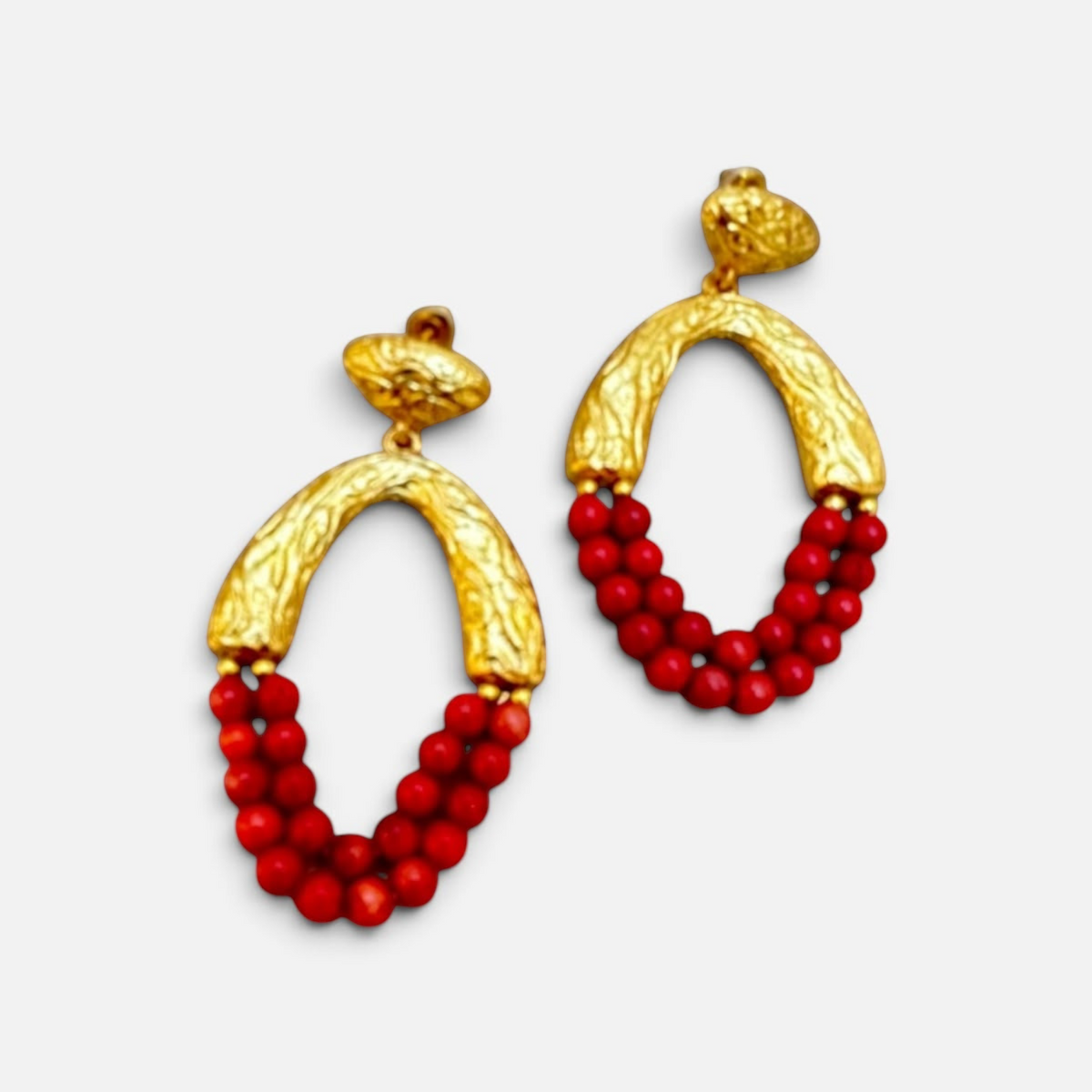 Jakris Rossa statement earrings featuring 24k gold plated textured bronze and vibrant red coral beaded drops.