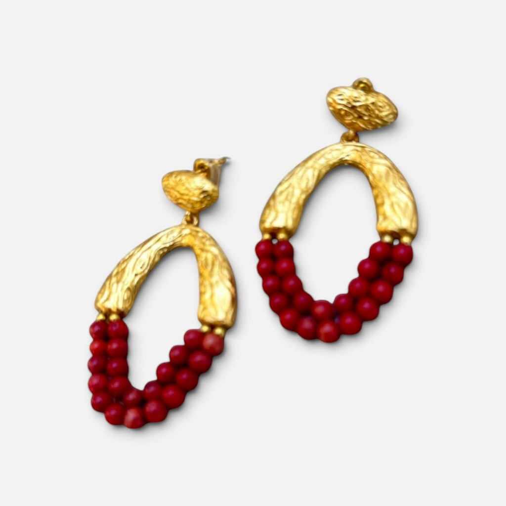 Jakris Rossa statement earrings featuring 24k gold-plated textured bronze and vibrant red coral beads.