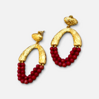 Jakris Rossa statement earrings featuring 24k gold-plated textured bronze and vibrant red coral beads.