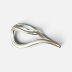 Jakris Reilly gold-plated two-finger ring with a modern, fluid sculptural design on a plain background.