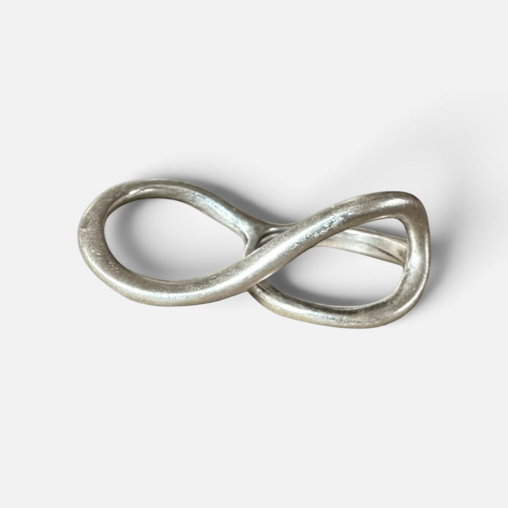 Jakris Reilly gold-plated two-finger ring with a smooth infinity-shaped design on a white background