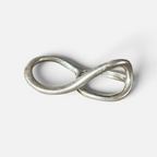 Jakris Reilly gold-plated two-finger ring with a smooth infinity-shaped design on a white background