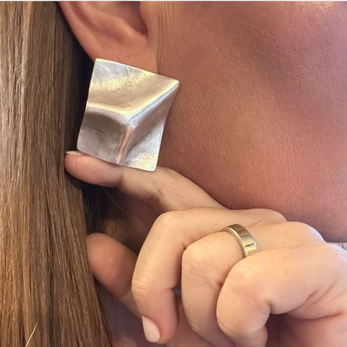Jakris Noila sculptural square earrings in antique silver plated brass with a geometric curved surface design.