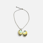 Jakris gold-plated oval locket necklace with an open design, featuring a delicate chain and symbolic phoenix motif.