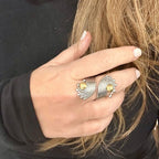 Jakris handmade adjustable ring in brass and white gold rhodium plating with a unique curved design on a hand