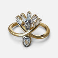 Jakris adjustable gold-tone ring featuring a decorative fan-shaped design with clear baguette and teardrop crystals.