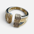 Jakris adjustable gold-plated ring featuring an open design with sparkling crystal accents on the ends.