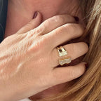 Jakris adjustable gold-plated ring featuring a modern open design with sparkling crystal accents on a woman's hand.