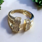 Jakris adjustable gold-plated ring featuring sparkling crystal accents and an open-ended design