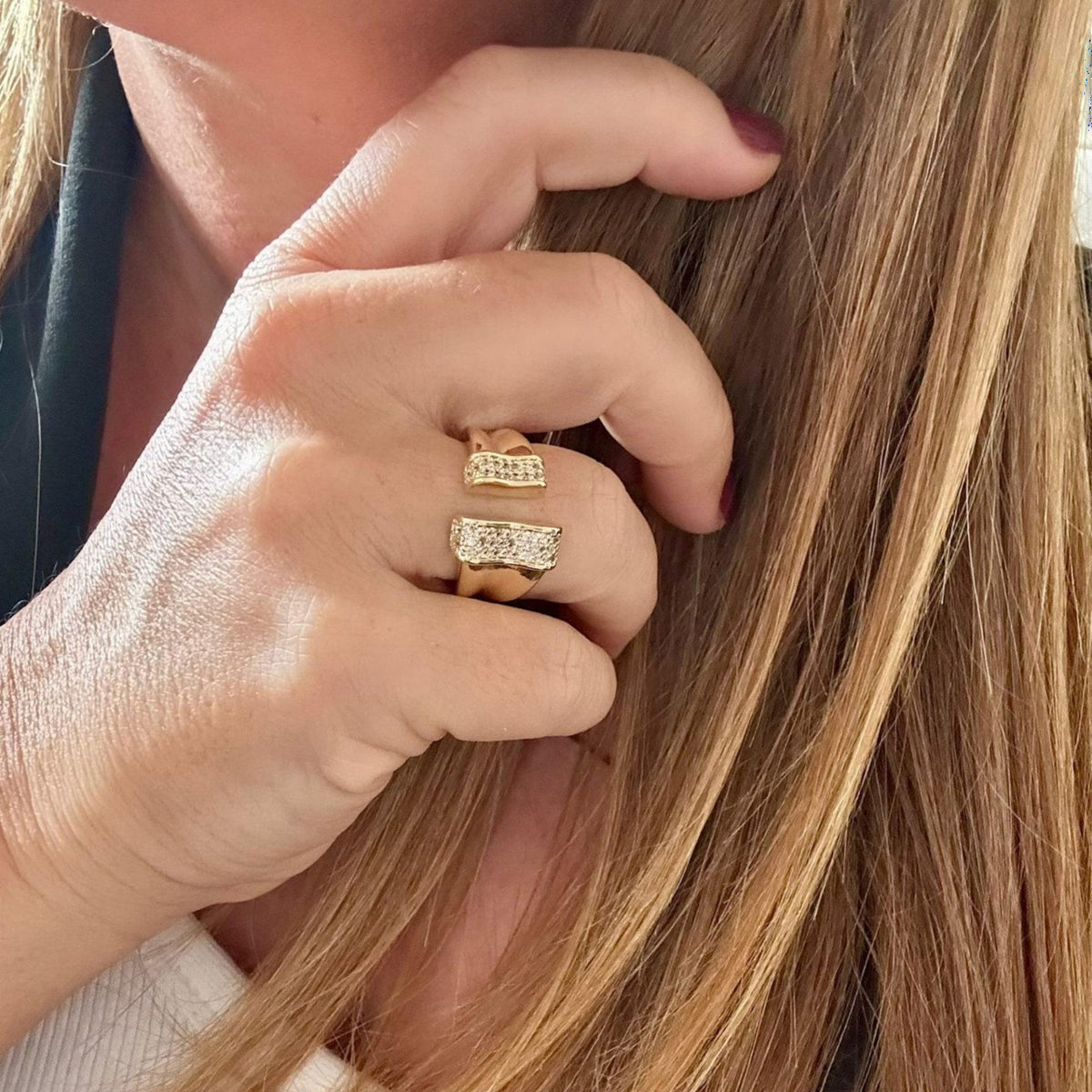 Jakris adjustable gold-plated ring featuring sparkling crystal accents on an open-style band worn on a finger
