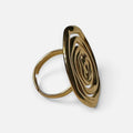 Jakris adjustable gold ring featuring a handcrafted artistic spiral design on a white surface.