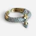 Jakris adjustable gold-plated arrow ring featuring sparkling white zircon stones in a modern open design.