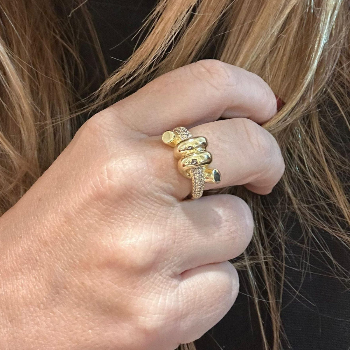 Jakris adjustable gold knot ring featuring sparkling zircon stone details worn on a finger