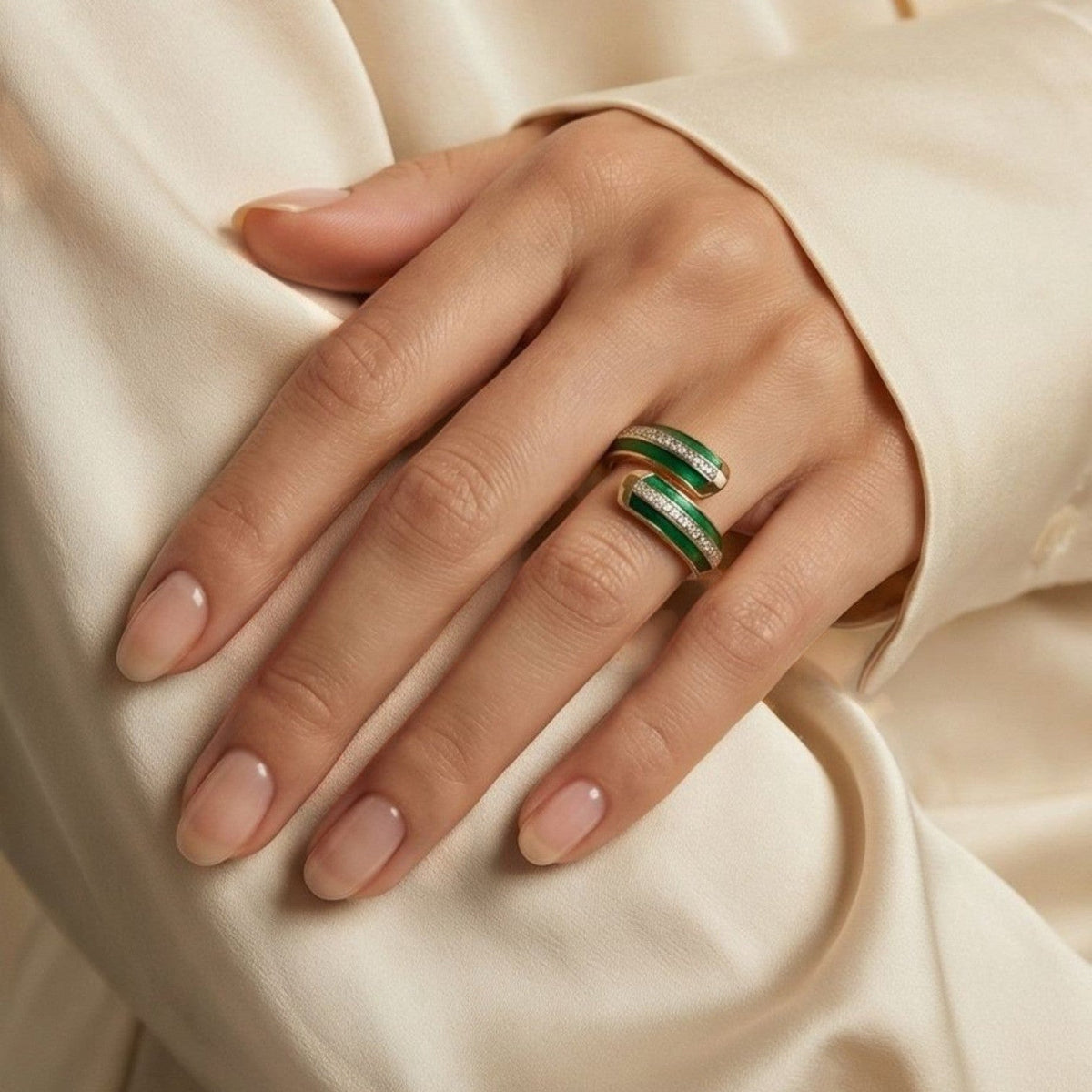 Jakris adjustable ring with green emerald-effect enamel and sparkling crystal accents worn on a hand