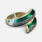 Jakris adjustable gold-tone ring featuring green enamel accents and a row of sparkling clear stones
