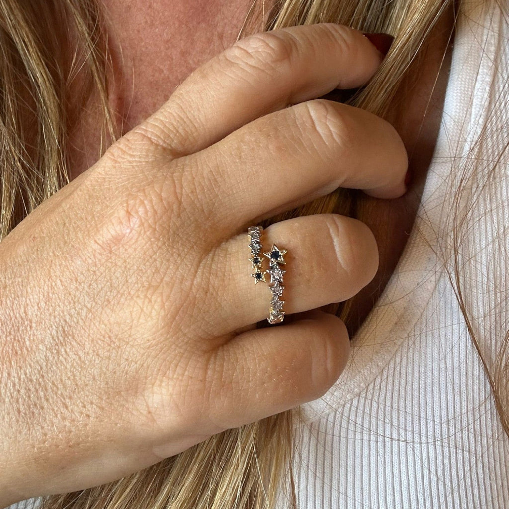 Jakris adjustable crossover ring featuring delicate star motifs with sparkling stones worn on a woman's finger