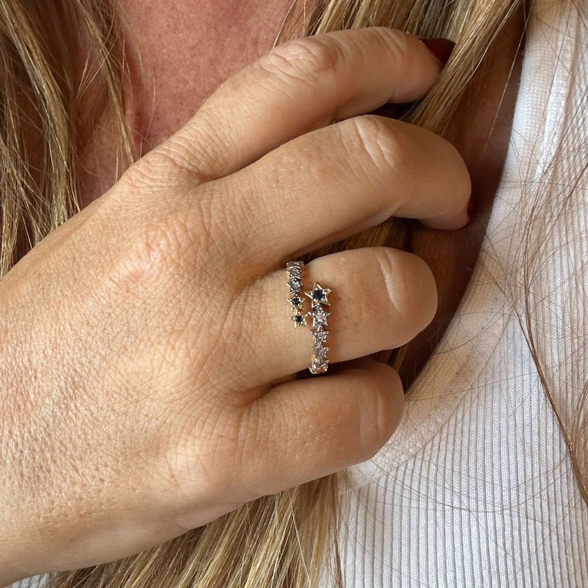 Jakris adjustable crossover ring featuring delicate star motifs with sparkling stones worn on a woman's finger