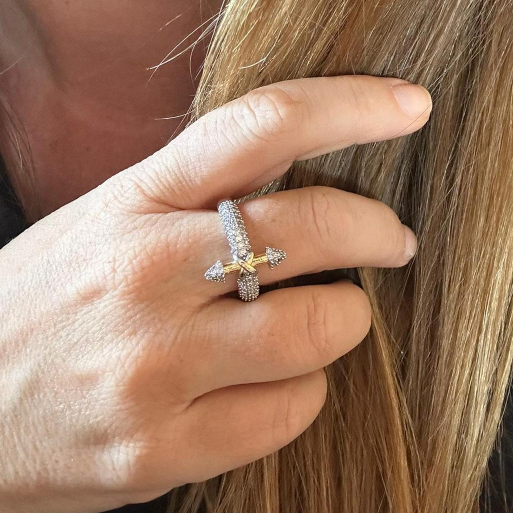 Jakris adjustable arrow ring featuring gold-plated accents and sparkling zircon stones worn on a woman's finger