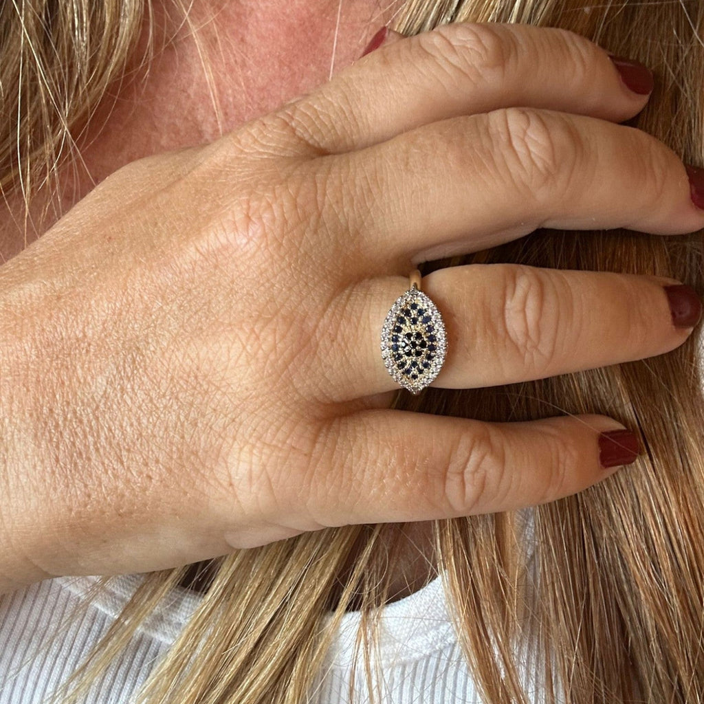 Jakris adjustable gold-tone ring featuring a marquise-shaped evil eye design with blue and white zircon stones