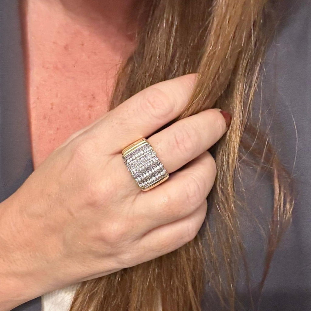 Jakris adjustable gold-tone ring featuring a wide band with rows of sparkling zircon stones worn on a finger