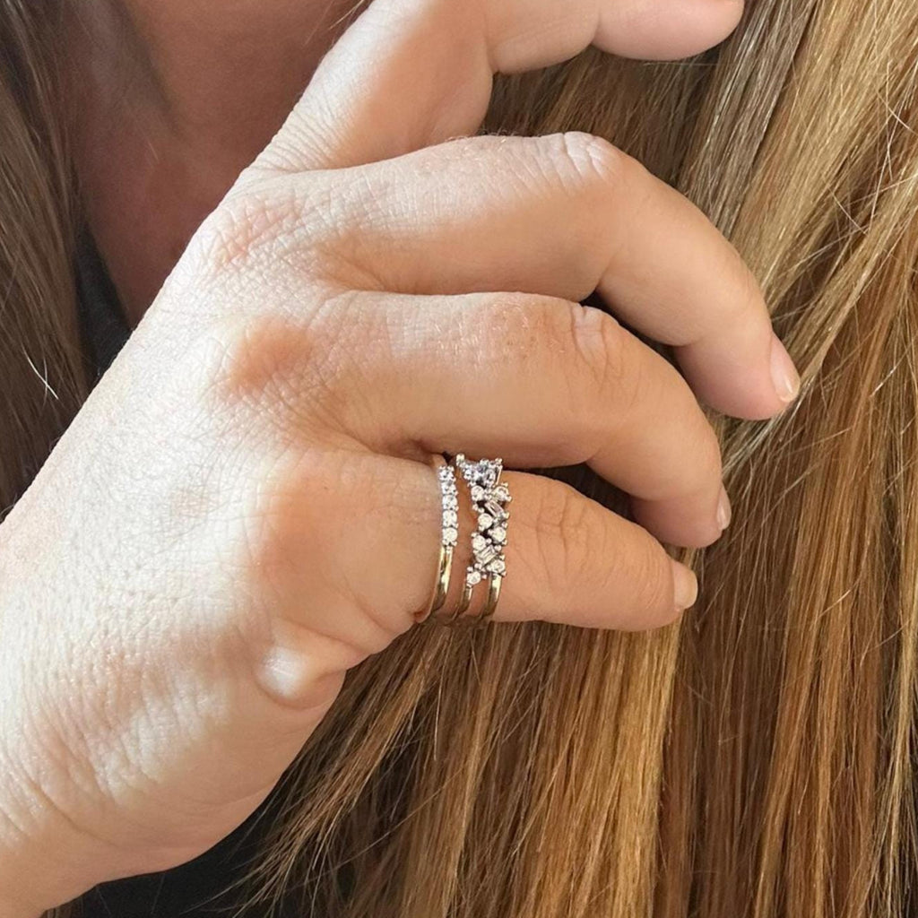Jakris adjustable gold ring with multiple bands and sparkling zircon crystal details worn on a woman's finger.