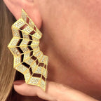 Jakris Art Deco fan-shaped gold earrings adorned with sparkling zircon stones worn on an ear