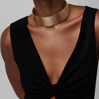 Jakris Aura altın rengi çok sıralı metal choker kolye, siyah elbise üzerinde modern ve şık bir görünüm sunuyor.