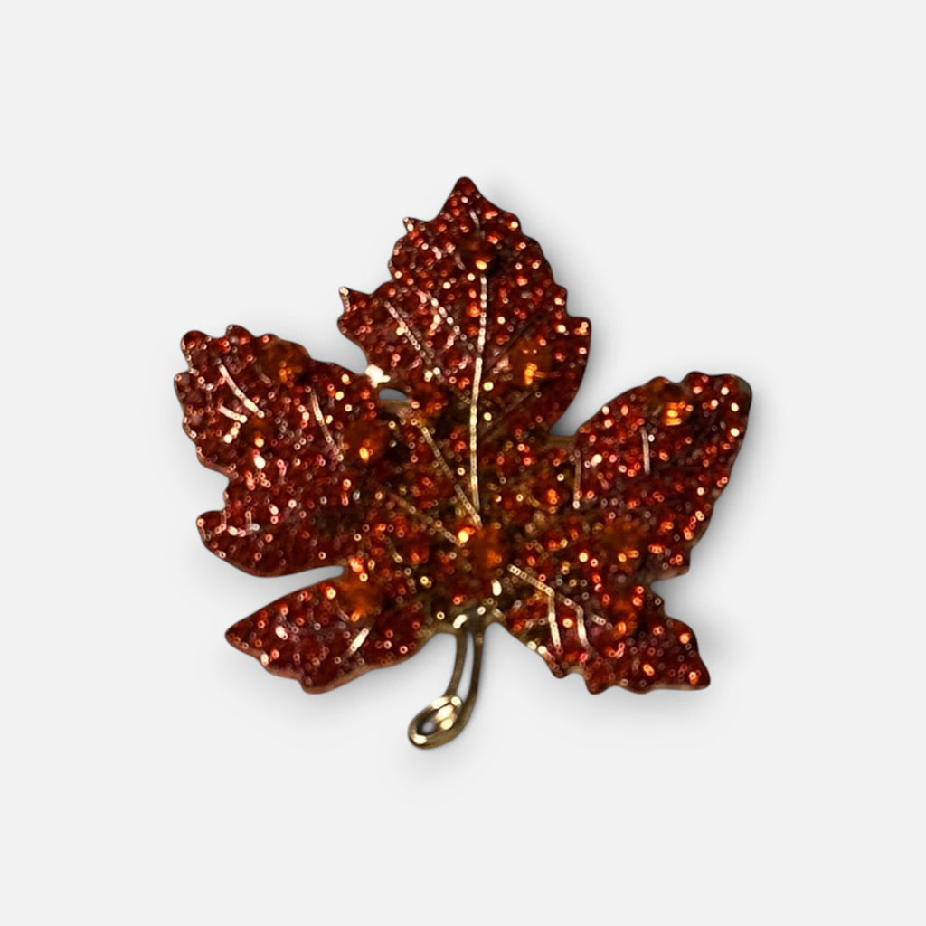 Jakris autumn maple leaf brooch featuring sparkling orange crystals and a gold-tone metal finish.
