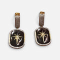 Jakris black star dangle earrings featuring gold star accents and pave crystal borders on a gold-tone base