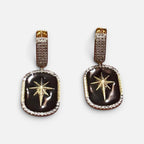Jakris black star dangle earrings featuring gold star accents and pave crystal borders on a gold-tone base