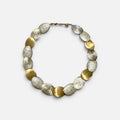 Jakris handcrafted limited edition necklace featuring alternating gold brass and white gold plated textured discs.