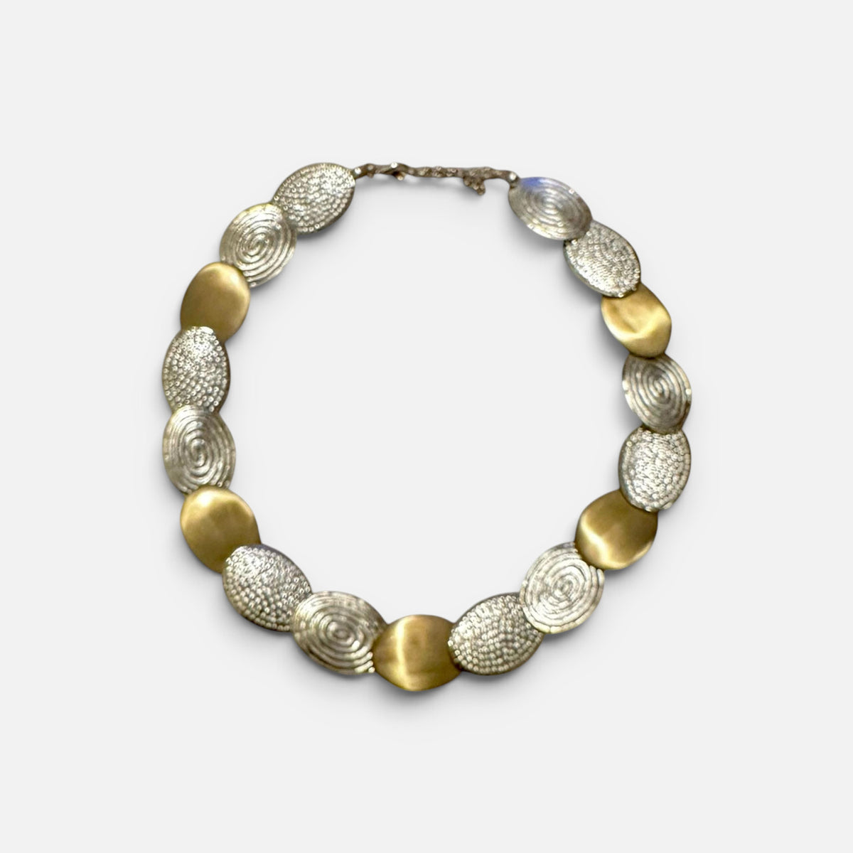Jakris handcrafted limited edition necklace featuring alternating gold brass and white gold plated textured discs.