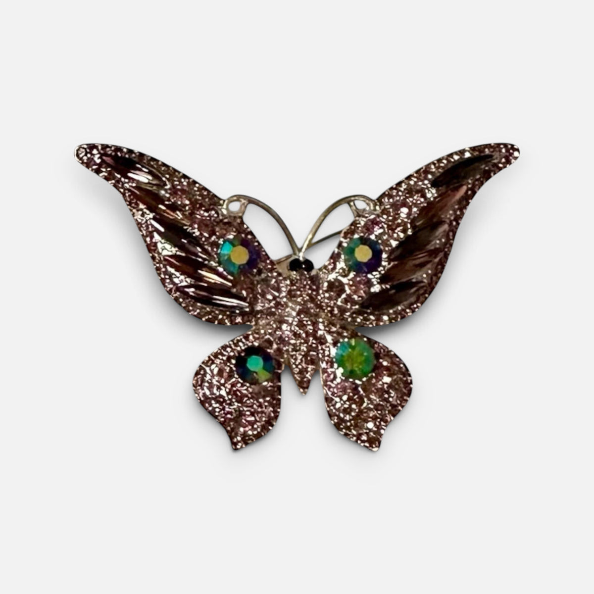 Jakris vintage butterfly brooch featuring shimmering pink textured metal and colorful crystal accents