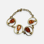 Jakris Calista oval amber mine detaylı altın kaplama pirinç bileklik, vintage esintili sanatsal tasarım.