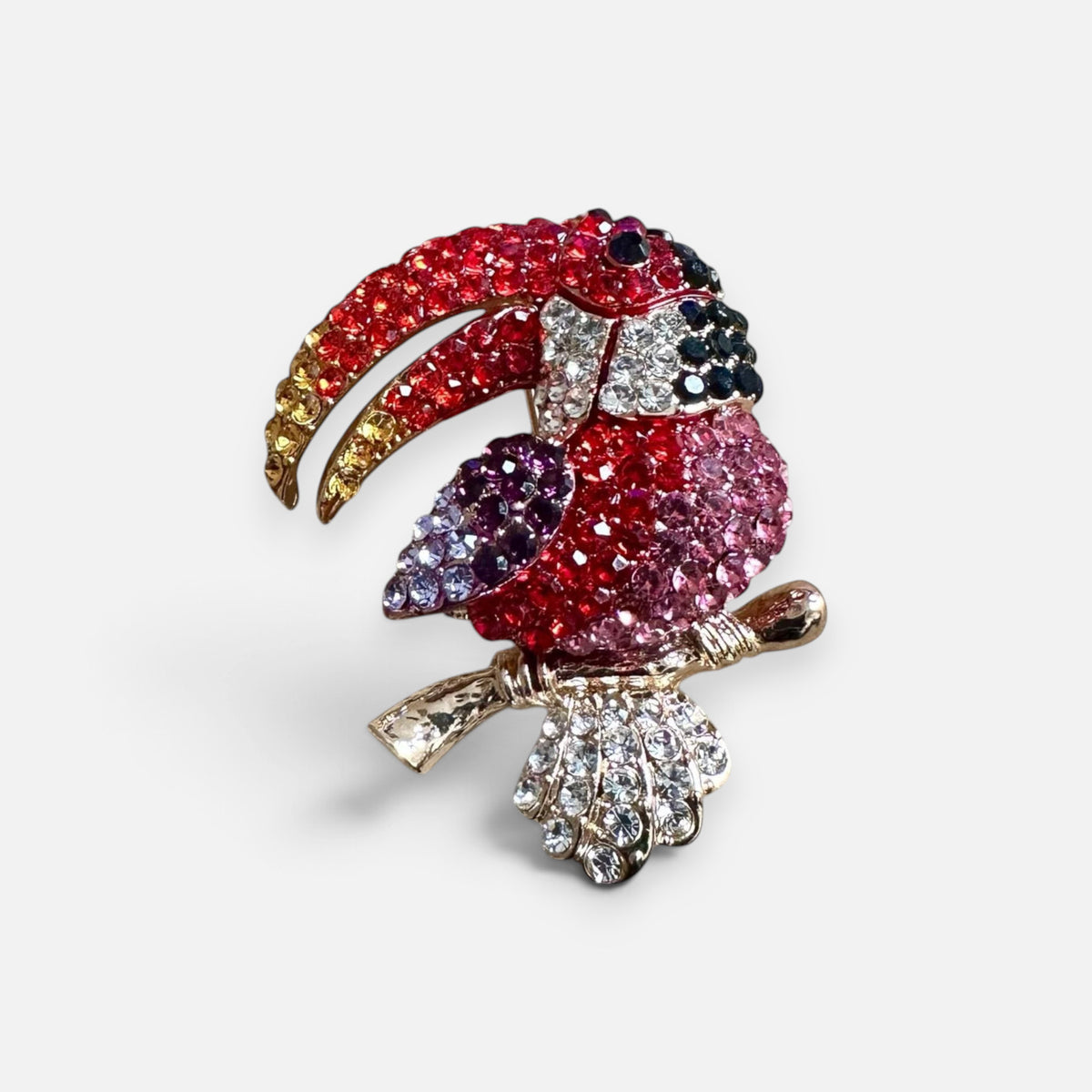 Jakris colorful toucan brooch featuring sparkling tropical bird design with red, pink, and clear crystal embellishments