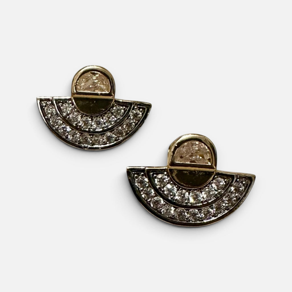 Jakris minimalist fan-shaped stud earrings featuring sparkling crystals in a polished gold-tone metal setting.