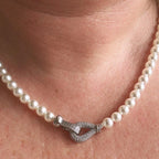 Jakris freshwater pearl choker necklace featuring a sparkling zircon-encrusted clasp worn around the neck
