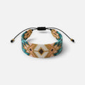 Jakris woven bead bracelet featuring a geometric pattern in turquoise, gold, pink, and white with adjustable cord.