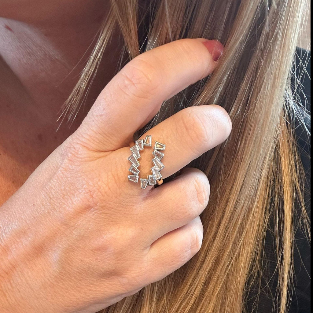 Jakris adjustable gold ring featuring a geometric open design with sparkling baguette crystals worn on a finger