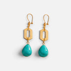Jakris geometric drop earrings featuring 24k gold-plated bronze and teardrop-shaped turquoise stones.