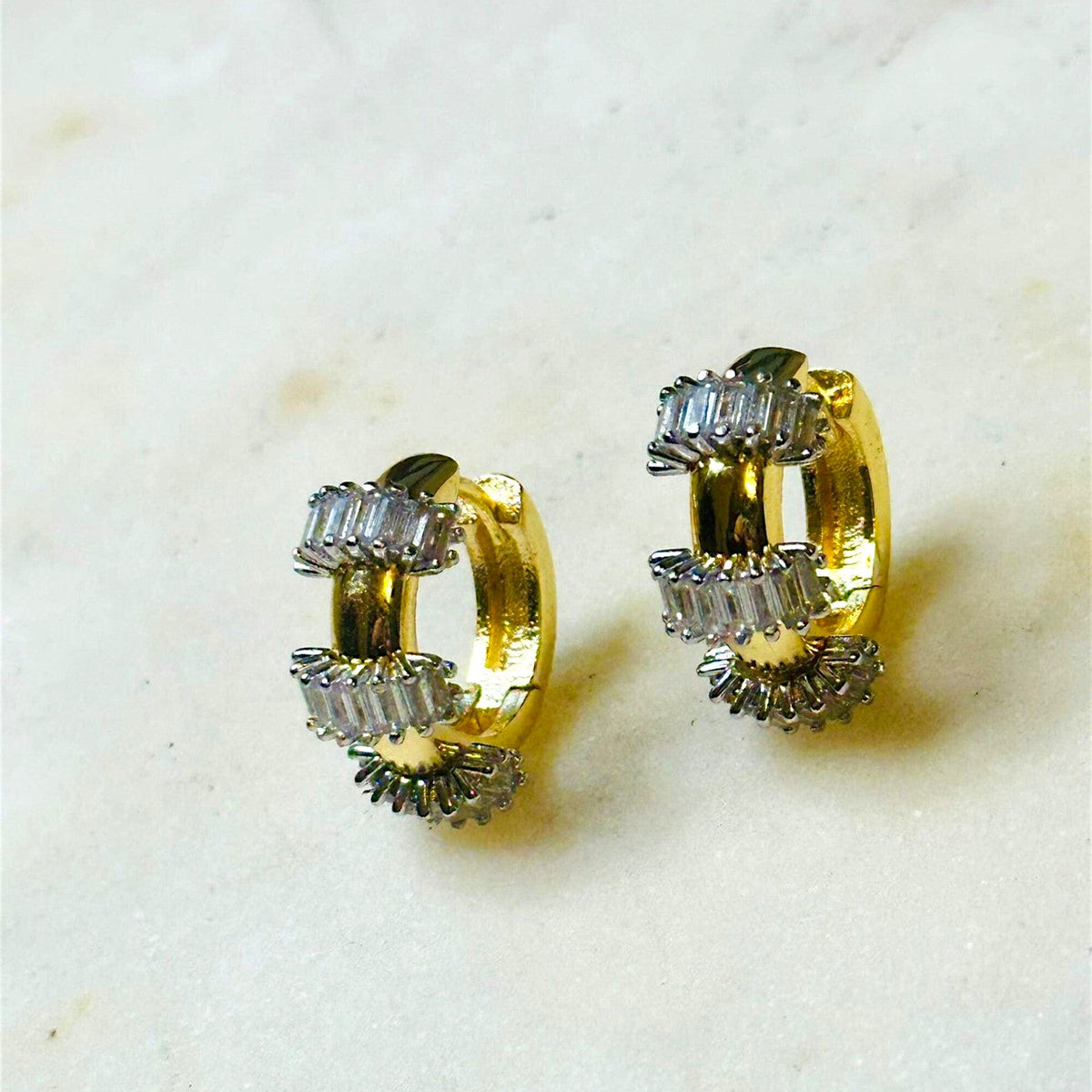 Jakris gold hoop earrings featuring small baguette-cut clear stones, perfect as an elegant Mother's Day gift.