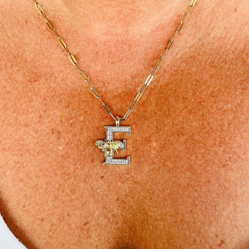 Jakris gold letter E pendant necklace featuring a sparkling zircon-encrusted design with a small bee detail