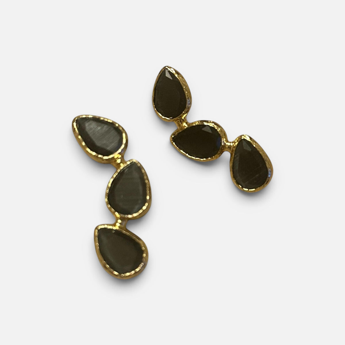 Jakris gold-tone drop earrings featuring three teardrop-shaped black stones in a dangling design