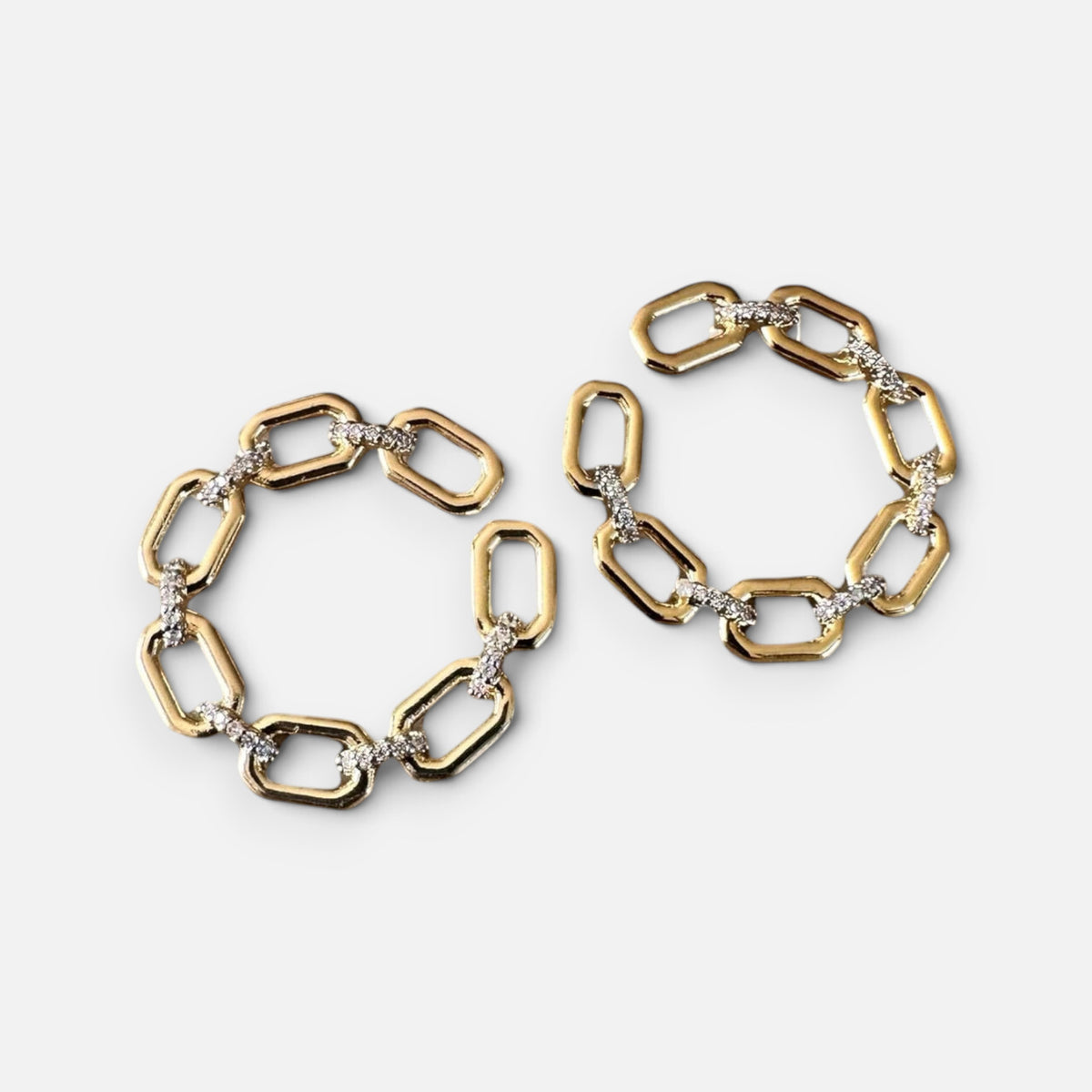 Jakris gold chain link hoop earrings with geometric design and sparkling crystal accents