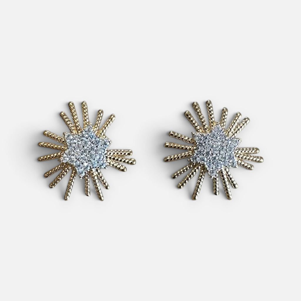 Jakris star-shaped stud earrings in gold tone with sparkling crystal embellishments and sunburst rays