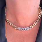 Jakris gold-plated Cuban chain necklace featuring a central section of sparkling cubic zirconia crystals.