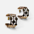 Jakris gold-plated hoop earrings featuring a thick dotted cutout design on a white background.