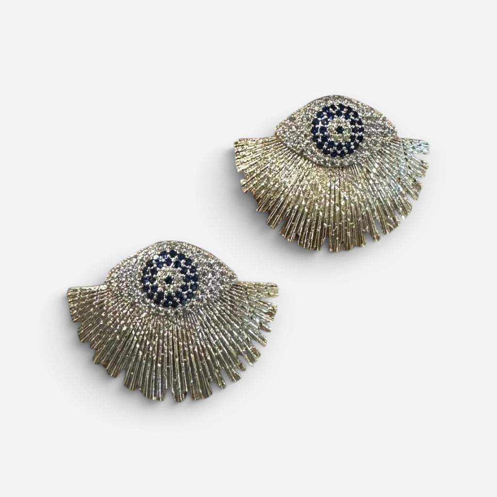 Jakris gold-plated fringe earrings featuring a blue evil eye nazar bead design with sparkling stone accents.