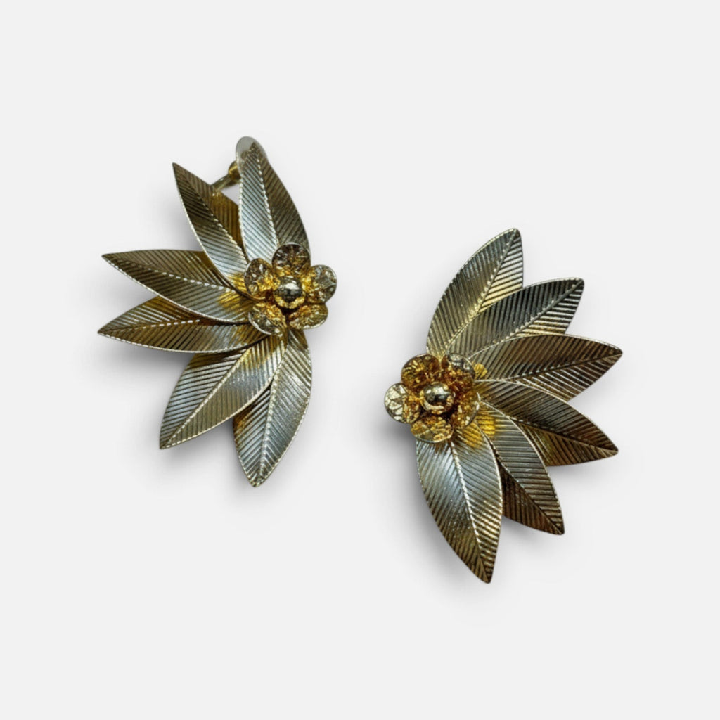 Jakris gold plated brass leaf-shaped earrings with central flower detail and textured finish for formal occasions.